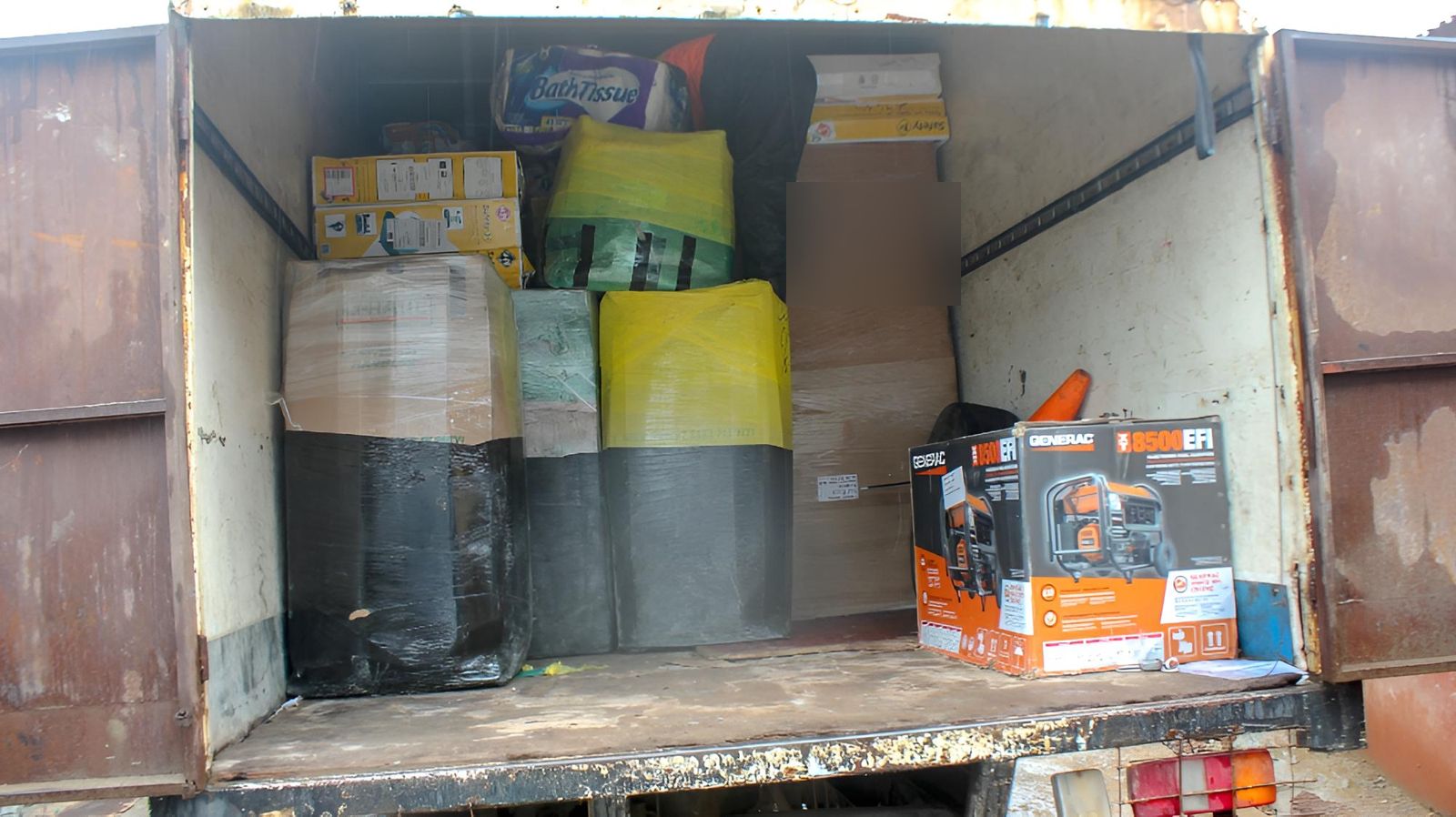 Boxes, bundles and a generator packed inside the truck